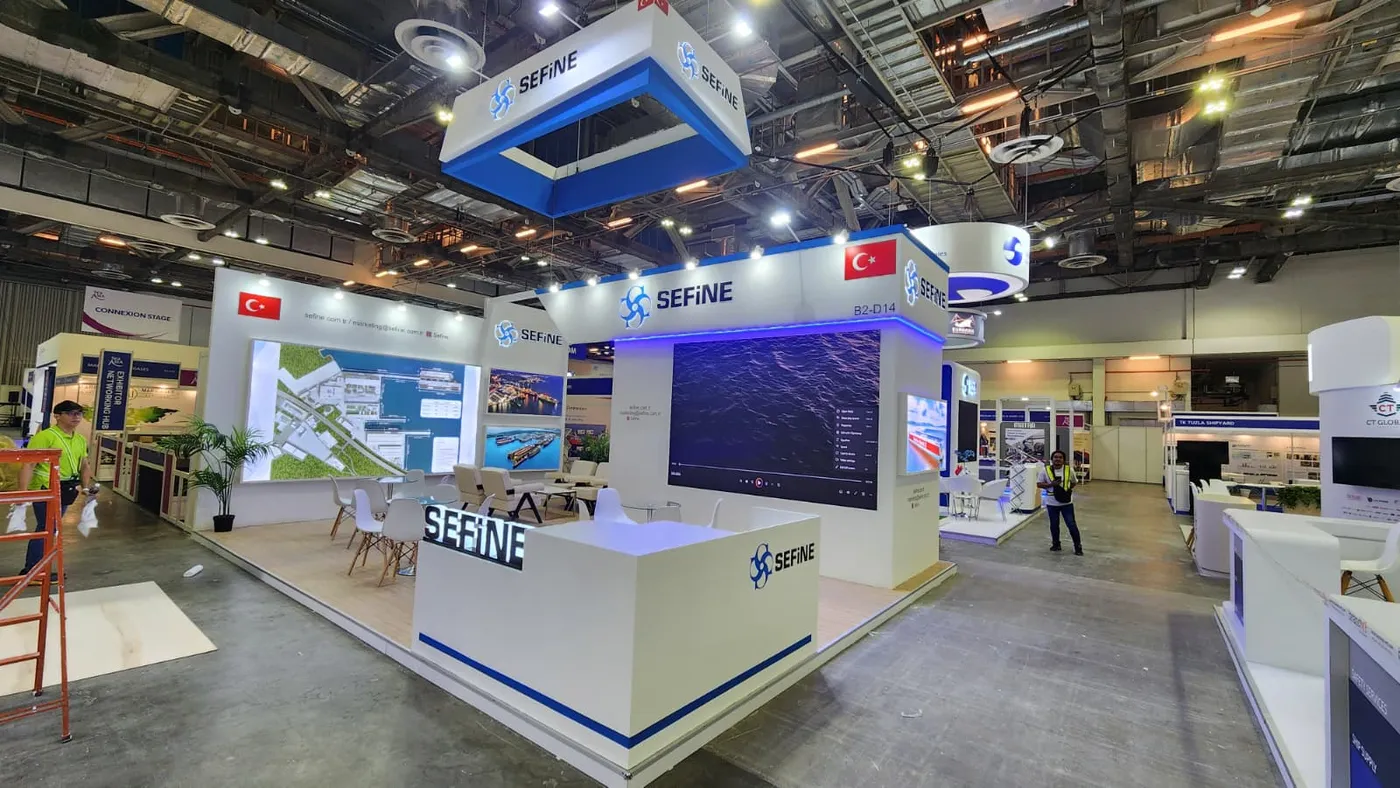 Green suspended-cube feature exhibition stand design by JOKO