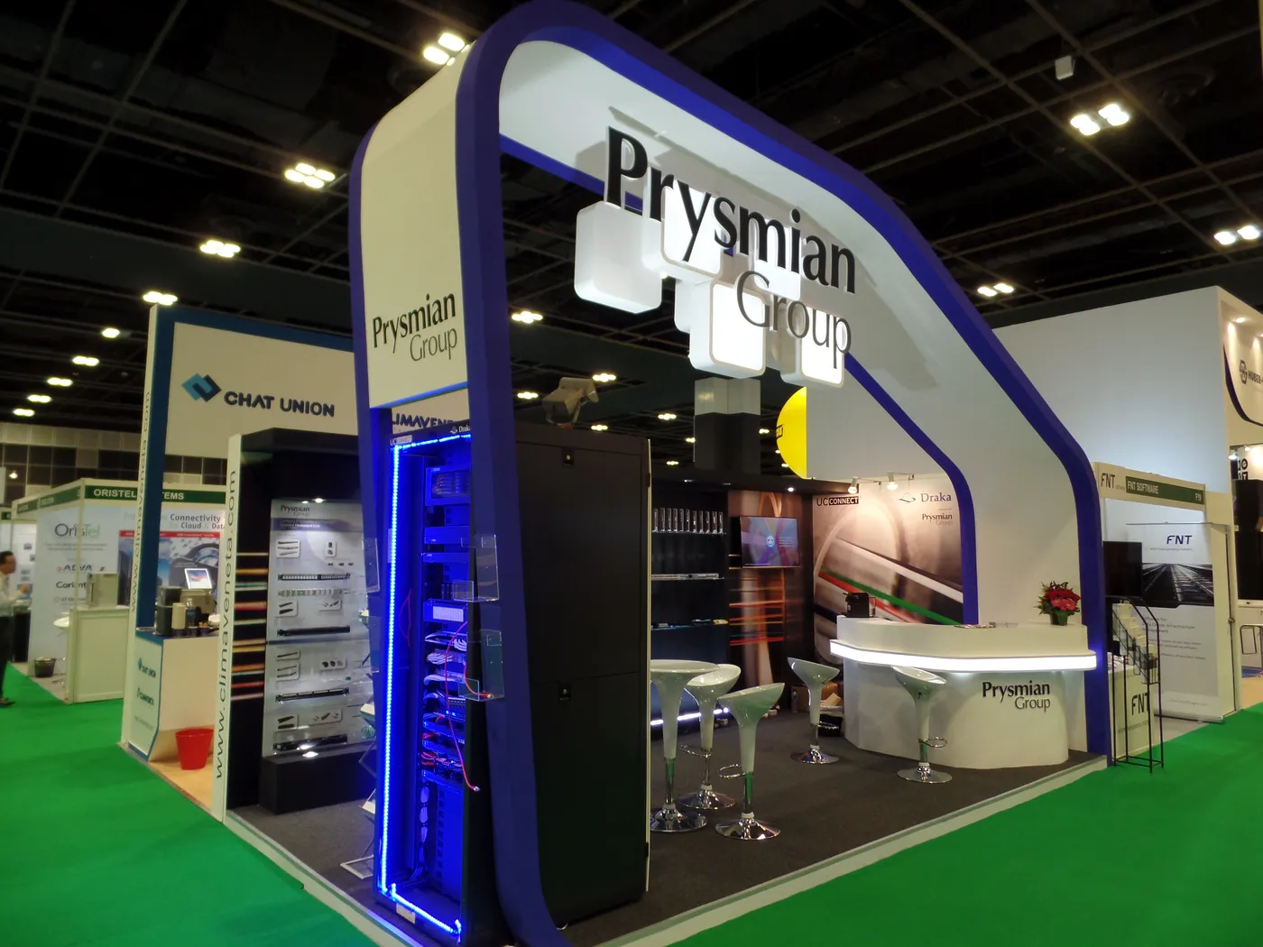 Custom exhibition stand with branded entrance archway designed by JOKO